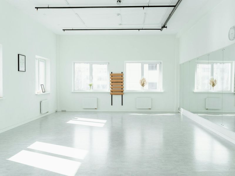 Minimalist training space with natural light and wooden floor